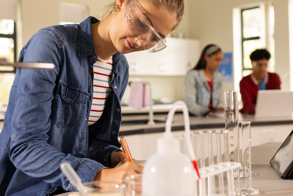 Estudiante en un laboratorio universitario durante una clase de ciencias, reflejando la calidad académica y la experiencia práctica en universidades estadounidenses.